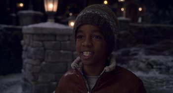 Movie still from “The Christmas Chronicles: Part Two” (2020), directed by Chris Columbus – A young boy wearing a brown jacket and a hat; Close Up shot, High angle