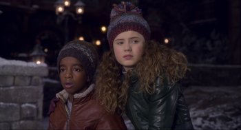 Movie still from “The Christmas Chronicles: Part Two” (2020), directed by Chris Columbus – Two young children wearing winter hats standing next to each other; Close Up shot, Low angle