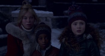 Movie still from “The Christmas Chronicles: Part Two” (2020), directed by Chris Columbus – A group of people standing next to each other in the snow; Close Up shot, Over the shoulder angle
