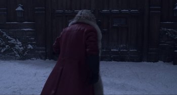 Movie still from “The Christmas Chronicles: Part Two” (2020), directed by Chris Columbus – A woman in a red coat walking in the snow; Wide shot, Over the shoulder angle