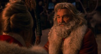 Movie still from “The Christmas Chronicles: Part Two” (2020), directed by Chris Columbus – A man with long hair and a white beard; Close Up shot, Over the shoulder angle