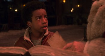 Movie still from “The Christmas Chronicles: Part Two” (2020), directed by Chris Columbus – A young boy is looking up at the sky; Close Up shot, Over the shoulder angle