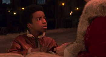 Movie still from “The Christmas Chronicles: Part Two” (2020), directed by Chris Columbus – A young boy in a leather jacket looking at another person; Close Up shot, Over the shoulder angle