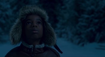 Movie still from “The Christmas Chronicles: Part Two” (2020), directed by Chris Columbus – A young boy wearing a jacket and a fur hat; Close Up shot, Low angle