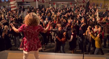 Movie still from “The Christmas Chronicles: Part Two” (2020), directed by Chris Columbus – A crowd of people standing in a room; Extreme Wide shot, High angle