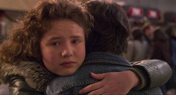 Movie still from “The Christmas Chronicles: Part Two” (2020), directed by Chris Columbus – A young woman is hugging a young man; Close Up shot, Over the shoulder angle
