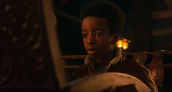 Movie still from “The Christmas Chronicles: Part Two” (2020), directed by Chris Columbus – A young boy is looking at a book; Close Up shot, Over the shoulder angle