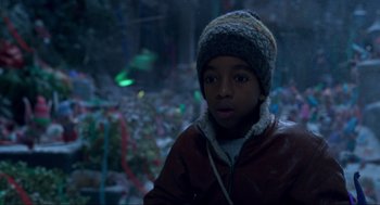 Movie still from “The Christmas Chronicles: Part Two” (2020), directed by Chris Columbus – A young boy wearing a red jacket and a gray hat; Close Up shot, Low angle