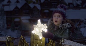Movie still from “The Christmas Chronicles: Part Two” (2020), directed by Chris Columbus – A little girl is holding a light up star; Close Up shot, Over the shoulder angle