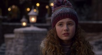 Movie still from “The Christmas Chronicles: Part Two” (2020), directed by Chris Columbus – A young girl wearing a colorful hat in the snow; Close Up shot, Over the shoulder angle