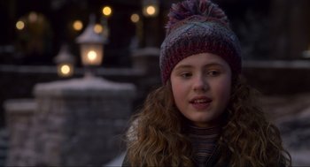 Movie still from “The Christmas Chronicles: Part Two” (2020), directed by Chris Columbus – A young girl wearing a knitted hat in the snow; Close Up shot, Over the shoulder angle