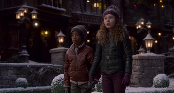 Movie still from “The Christmas Chronicles: Part Two” (2020), directed by Chris Columbus – Two children are standing in the snow together; Medium shot, Low angle