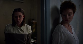 Movie still from “Crimes of the Future” (2022), directed by David Cronenberg – A woman standing next to a man leaning against a wall; Medium shot, Low angle