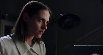 Movie still from “Crimes of the Future” (2022), directed by David Cronenberg – A woman in a white shirt is looking to her left; Close Up shot, Low angle