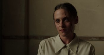 Movie still from “Crimes of the Future” (2022), directed by David Cronenberg – A person wearing a white shirt; Close Up shot, Low angle