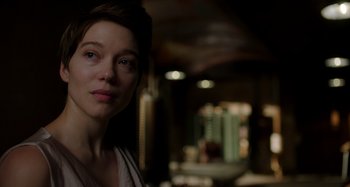 Movie still from “Crimes of the Future” (2022), directed by David Cronenberg – A person in a dark room; Close Up shot, Over the shoulder angle