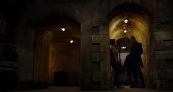 Movie still from “Crimes of the Future” (2022), directed by David Cronenberg – Two men are standing in an underground tunnel; Wide shot, Low angle