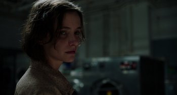 Movie still from “Crimes of the Future” (2022), directed by David Cronenberg – A person wearing a jacket; Close Up shot, Over the shoulder angle