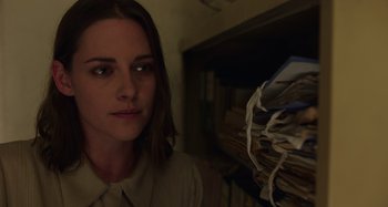 Movie still from “Crimes of the Future” (2022), directed by David Cronenberg – A woman standing in front of a pile of papers; Close Up shot, Low angle
