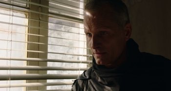 Movie still from “Crimes of the Future” (2022), directed by David Cronenberg – A person looking out of a window; Close Up shot, Low angle