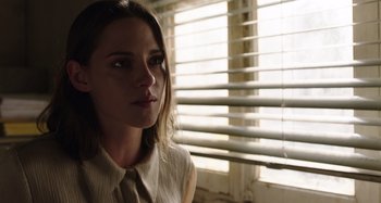 Movie still from “Crimes of the Future” (2022), directed by David Cronenberg – A young woman is looking out of a window; Close Up shot, Over the shoulder angle