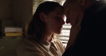 Movie still from “Crimes of the Future” (2022), directed by David Cronenberg – A man and a woman face to face in front of a window; Close Up shot, Low angle