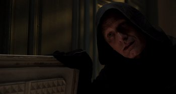 Movie still from “Crimes of the Future” (2022), directed by David Cronenberg – A man in a black hooded jacket looking at the camera; Close Up shot, Low angle
