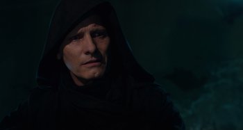 Movie still from “Crimes of the Future” (2022), directed by David Cronenberg – A man in a black robe and a black hood; Close Up shot, Low angle