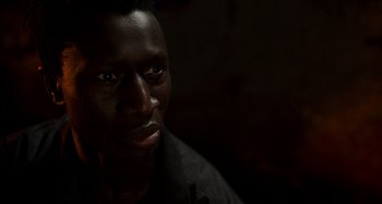 Movie still from “Crimes of the Future” (2022), directed by David Cronenberg – A man's face in the dark; Close Up shot, Low angle