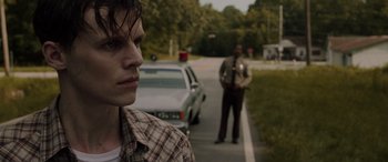 Movie still from “The Conjuring: The Devil Made Me Do It” (2021), directed by Michael Chaves – A man standing on the side of a road next to a police officer; Close Up shot, Over the shoulder angle