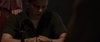 Movie still from “The Conjuring: The Devil Made Me Do It” (2021), directed by Michael Chaves – A man sitting at a table looking down at his watch; Close Up shot, Over the shoulder angle