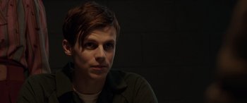 Movie still from “The Conjuring: The Devil Made Me Do It” (2021), directed by Michael Chaves – A man in a black shirt is sitting in a dark room; Close Up shot, Over the shoulder angle