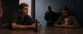 Movie still from “The Conjuring: The Devil Made Me Do It” (2021), directed by Michael Chaves – A group of men sitting around a table; Medium shot, Over the shoulder angle