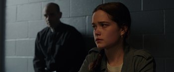 Movie still from “The Conjuring: The Devil Made Me Do It” (2021), directed by Michael Chaves – A young woman sitting in front of a brick wall; Close Up shot, Over the shoulder angle