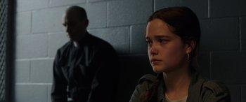 Movie still from “The Conjuring: The Devil Made Me Do It” (2021), directed by Michael Chaves – A young girl sitting in front of a brick wall; Close Up shot, Over the shoulder angle