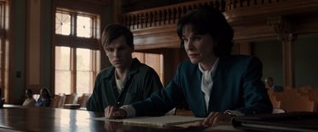 Movie still from “The Conjuring: The Devil Made Me Do It” (2021), directed by Michael Chaves – Two people sitting at a table with papers in front of them; Medium shot, Over the shoulder angle