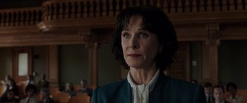 Movie still from “The Conjuring: The Devil Made Me Do It” (2021), directed by Michael Chaves – A woman with a cross on her neck standing in a courtroom; Close Up shot, Low angle