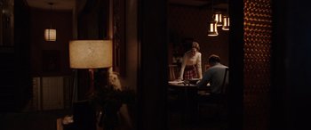 Movie still from “The Conjuring: The Devil Made Me Do It” (2021), directed by Michael Chaves – Two people sitting at a table in a room; Wide shot, Over the shoulder angle