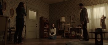 Movie still from “The Conjuring: The Devil Made Me Do It” (2021), directed by Michael Chaves – A woman sitting on the ground in a room; Wide shot, High angle