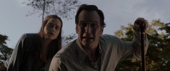Movie still from “The Conjuring: The Devil Made Me Do It” (2021), directed by Michael Chaves – A man and a woman standing next to each other in front of a tree; Close Up shot, Low angle