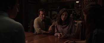 Movie still from “The Conjuring: The Devil Made Me Do It” (2021), directed by Michael Chaves – A man and a woman sitting at a wooden table; Medium shot, Over the shoulder angle