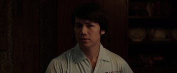 Movie still from “The Conjuring: The Devil Made Me Do It” (2021), directed by Michael Chaves – A man in a white shirt is looking at the camera; Close Up shot, Low angle