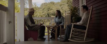 Movie still from “The Conjuring: The Devil Made Me Do It” (2021), directed by Michael Chaves – A man and a woman sitting on a porch; Wide shot, Over the shoulder angle