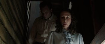 Movie still from “The Conjuring: The Devil Made Me Do It” (2021), directed by Michael Chaves – A man and a woman standing next to each other; Medium shot, Low angle