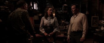 Movie still from “The Conjuring: The Devil Made Me Do It” (2021), directed by Michael Chaves – A woman standing next to two men in a room; Medium shot, Over the shoulder angle