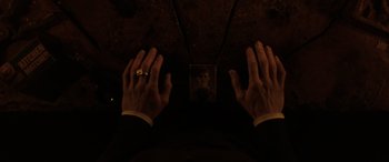 Movie still from “The Conjuring: The Devil Made Me Do It” (2021), directed by Michael Chaves – A man wearing a gold ring and a gold ring finger; Extreme Close Up shot, Overhead angle