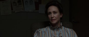 Movie still from “The Conjuring: The Devil Made Me Do It” (2021), directed by Michael Chaves – A woman sitting in a chair looking at the camera; Close Up shot, Over the shoulder angle