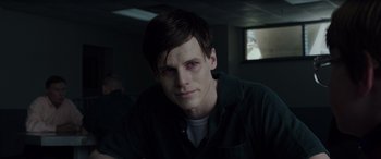 Movie still from “The Conjuring: The Devil Made Me Do It” (2021), directed by Michael Chaves – A young man with dark eyes stares into the camera; Close Up shot, Over the shoulder angle