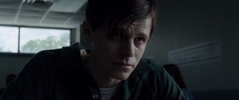 Movie still from “The Conjuring: The Devil Made Me Do It” (2021), directed by Michael Chaves – A young man with short brown hair wearing a green shirt; Close Up shot, Over the shoulder angle