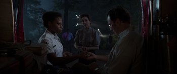 Movie still from “The Conjuring: The Devil Made Me Do It” (2021), directed by Michael Chaves – A group of people standing around each other in the dark; Medium shot, Over the shoulder angle